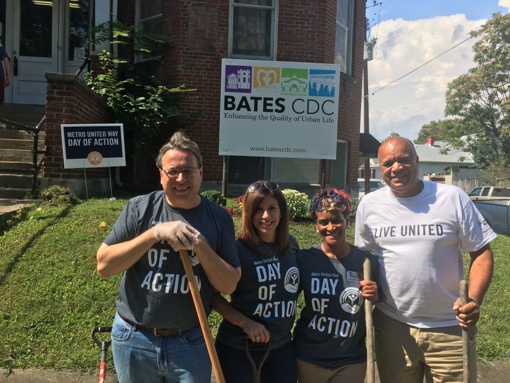 Theresa with United Way workers holding shovels