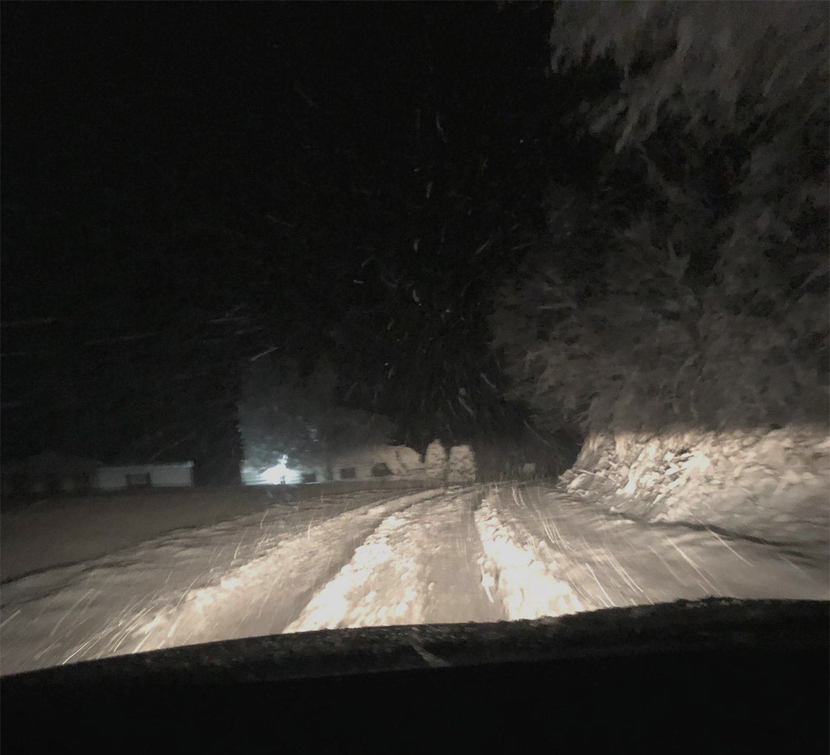 a snowy road at night